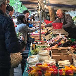 People buying food at an outdoor market