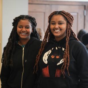 Two female Hope Forward students smiling at the camera