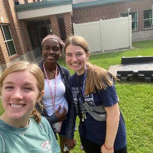 Three female Hope Forward students smiling for a selfie