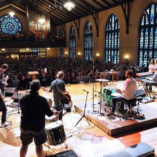 A worship band plays in front of a crowd at Dimnent Memorial Chapel.