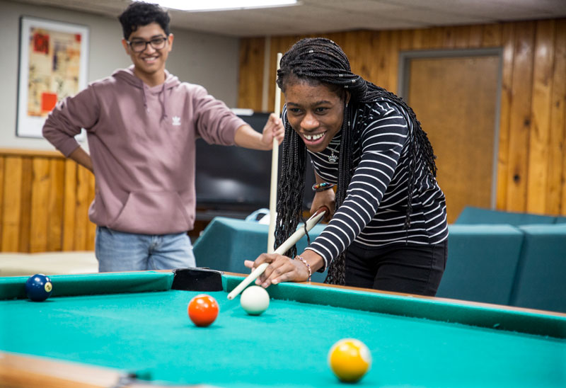 Two Phelps Scholars playing pool