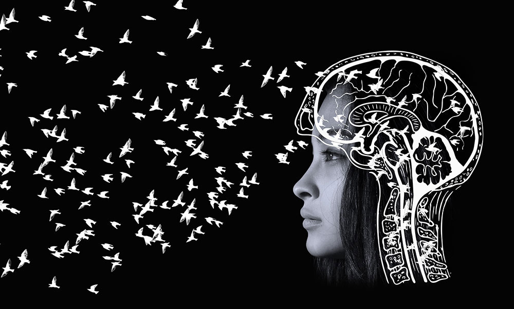 Stylized depiction of a woman sending birds flying out of her mind