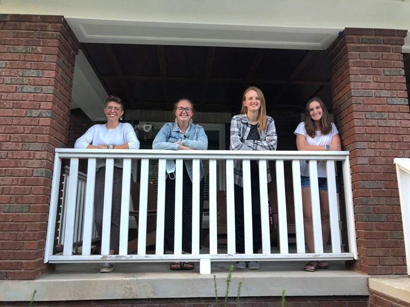 Four HAIC executive board members on the porch of the Keppel House